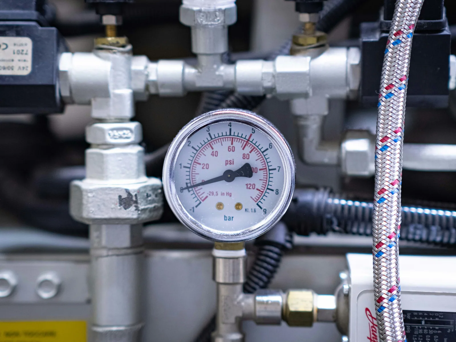 Plumbing system pressure gauge and water lines showing diagnostic testing